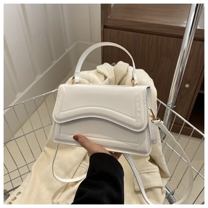 Minimalist white leather crossbody bag with wave flap design in metal shopping cart