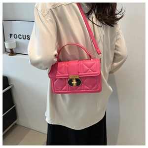 Detailed close-up of pink quilted PU leather handbag with elegant golden twist lock