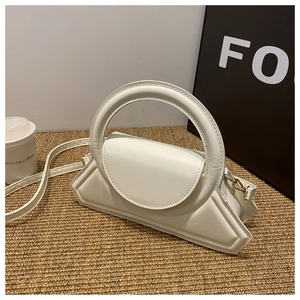 White geometric structured crossbody bag with distinctive round handle and leather strap