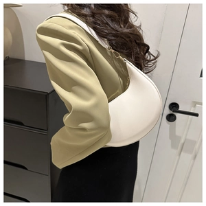 Detail of white PU crescent shoulder bag with golden metal hooks and fine stitching