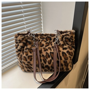 Detail of leopard print faux fur tote bag with brown straps and silver metal chain links