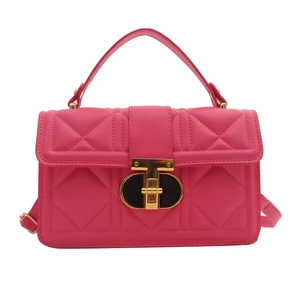 Rose pink quilted crossbody bag with golden hardware and adjustable strap on white background