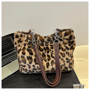 Detail of leopard print faux fur tote bag with leather strap and silver chain links