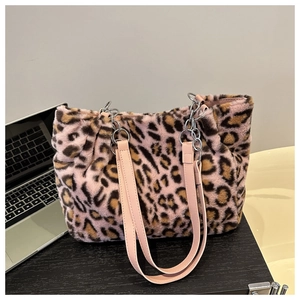 Detail of pink leopard faux fur tote bag with plush texture and silver chain strap