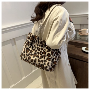 Detail of trendy leopard print plush shoulder bag with silver metal chain strap