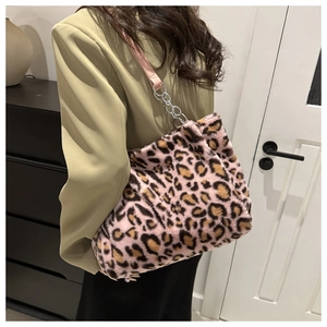 Detailed close-up of leopard print faux fur tote bag with pink leather and metal chain