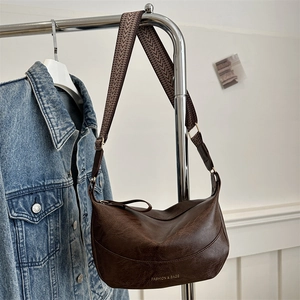 Vintage dark brown half-moon hobo crossbody bag with a wide patterned strap