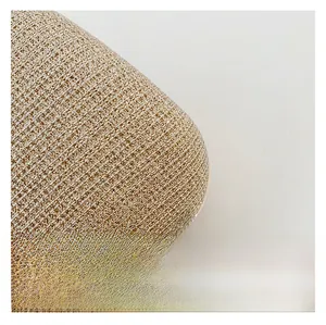 Macro shot of shimmering champagne gold woven texture on a stylish chain crossbody bag