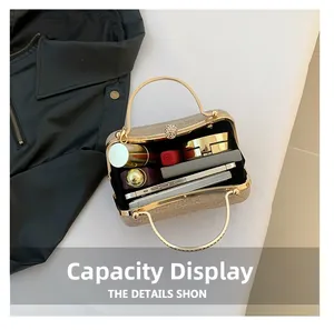 Detail showing internal capacity of the evening clutch bag with cosmetics and phone