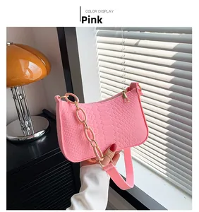 Pink faux crocodile leather shoulder bag detail with chunky chain and gold zipper
