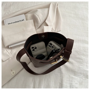 Detail view of large dark brown bucket bag interior showing spacious storage capacity