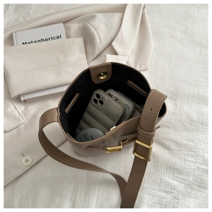 Top-down view of khaki bucket bag showing spacious interior with magnetic closure