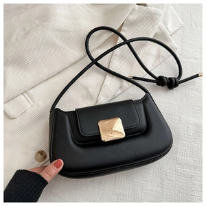 Detail of black crossbody bag with large square gold buckle and smooth leather finish