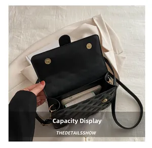 Internal view of black quilted crossbody bag showing space for phone and wallet