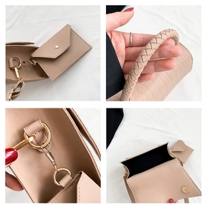 Detail of beige crocodile embossed bag with braided handle and gold-tone hardware fasteners