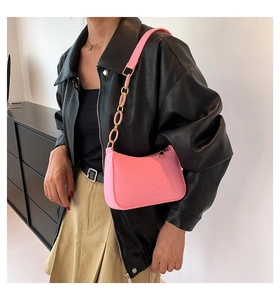 Chic pink shoulder bag with faux crocodile pattern and stylish acrylic chain strap