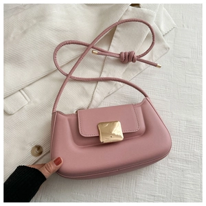 Pink leather rectangular shoulder bag with golden buckle on white textured background