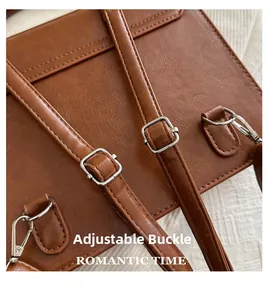 Detail of adjustable silver buckle and stitching on brown vintage backpack strap
