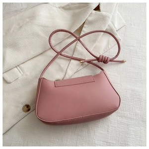 Pink minimalist faux leather shoulder bag with chic gold hardware knot detail and sleek strap