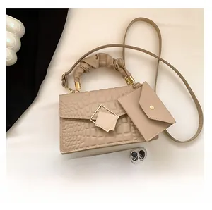 Beige faux crocodile skin handbag with pleated handle and matching mini envelope pouch