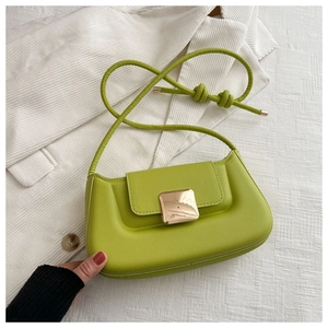 Top view of lime green shoulder bag with gold square buckle on corduroy fabric