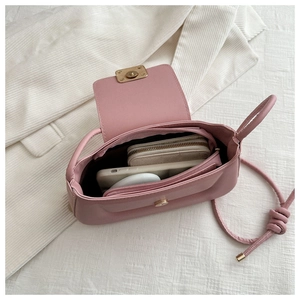 Detailed interior of the pink crossbody bag showing a zipper pocket and spacious compartment