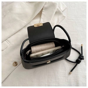 Internal view of black PU leather shoulder bag showing storage space for phone and wallet