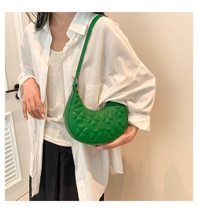 Detail of green hobo bag with clover embossing and adjustable leather strap