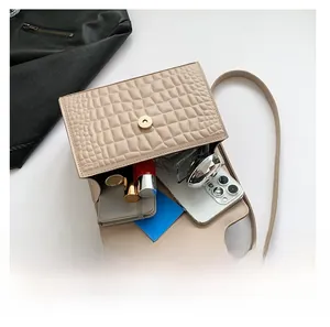 Top view showing the spacious interior of the cream crocodile embossed crossbody bag