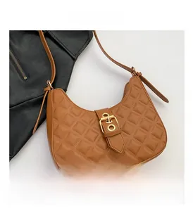Detailed close-up of brown quilted PU leather hobo bag with a gold buckle closure