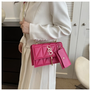 Detail of rose pink quilted crossbody bag with gold chain and matching coin purse charm