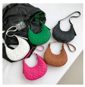 Detailed flat lay of half-moon underarm bags with clover embossing in five vivid colors