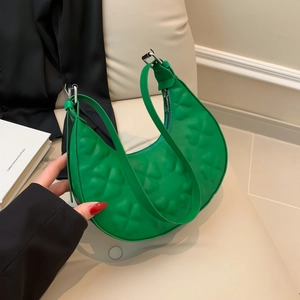Vibrant green hobo bag with clover embossing and minimalist half-moon shape
