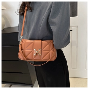 Detail view of brown quilted leather crossbody bag with iconic gold H metal clasp