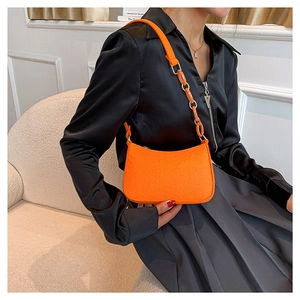 Bright orange crocodile pattern faux leather half-moon bag with acrylic chain decoration