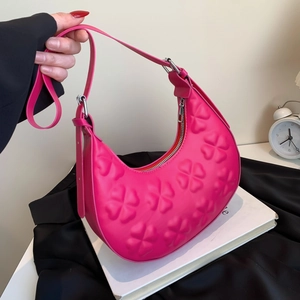 Rose pink crescent underarm bag with clover embossing and adjustable shoulder strap