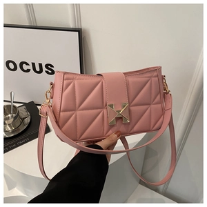 Close-up of pink quilted leather shoulder bag with elegant golden H-shaped metal clasp