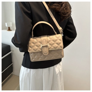 Quilted beige crossbody bag with H-buckle shown on model with casual outfit
