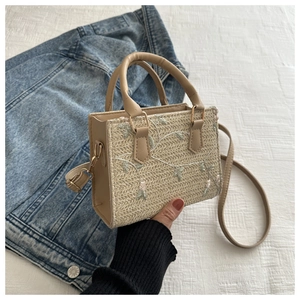 Woven straw handbag with floral embroidery and brown PU leather trim for women