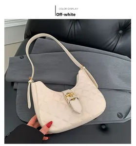 Detail of beige hobo bag with quilted rhombus pattern and golden metal buckle closure
