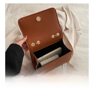 Interior view showing the capacity of a brown chain bag with V-quilted leather finish
