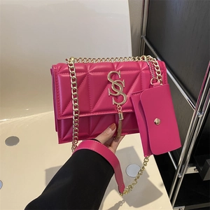 Fashionable magenta quilted shoulder bag with gold hardware and chain strap