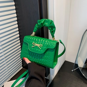 Bright green crocodile pattern square handbag with gold bow and pleated handle