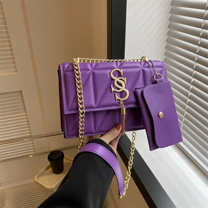Chic purple quilted shoulder bag with gold chain strap and mini pouch on model