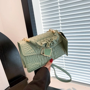 Mint green crocodile embossed crossbody bag with pleated handle and gold buckle