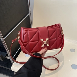 Minimalist red leather crossbody bag with geometric quilting and golden H buckle