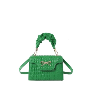 Green faux-crocodile rectangular handbag with pleated handle and golden bow accent