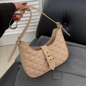 Quilted beige underarm bag with diamond stitching and adjustable leather shoulder strap