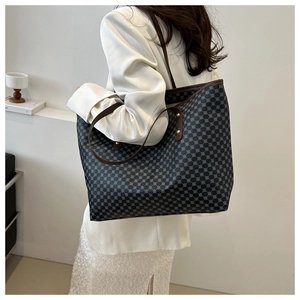 Detail of vintage printed tote bag showing large capacity and textured canvas shoulder strap
