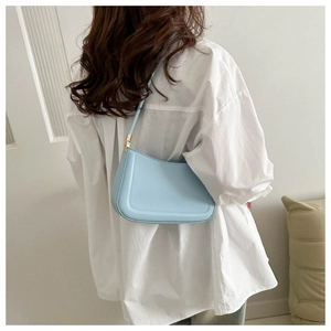 Chic light blue minimalist shoulder bag with elegant gold metal hardware details
